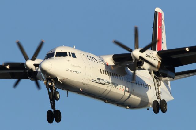 — — - A Cityjet Fokker F50, approaches London City Airport.