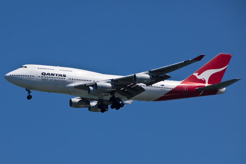 Boeing 747-200 (VH-OJQ) - Note the "5th" engine on the port wing.  Ferrying a replacement engine all the way from Australia for one that blew up on a company aircraft the day before.