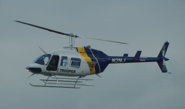 Bell JetRanger (N2NJ) - MORRISTOWN, NEW JERSEY, USA-JULY 24, 2020: A New Jersey State Police Helicopter, registration number N2NJ, is seen shortly before landing at Morristown Municipal Airport. The NJSP will help provide security for the arrival, in several hours, of President Trump on board Air Force One.