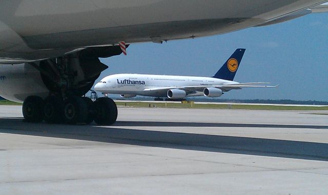 Airbus A380-800 — - A380 viewed from under a 777