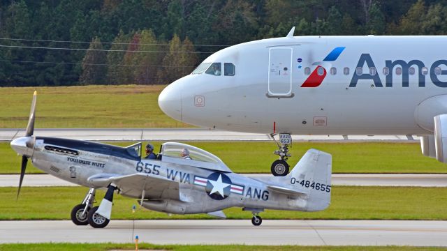 Airbus A320 (N653AW) - American Airlines A320 (N653AW) taxiing next to the Collings Foundation TF-51D "Toulouse Nuts" on 10/21/2017 at 5:23 PM.