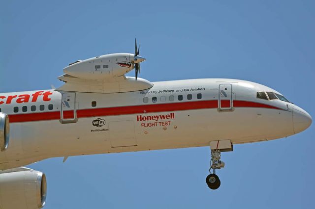 Boeing 757-200 (N757HW) - Honeywell Boeing 757-225 N757HW engine testbed returning to Phoenix Sky Harbor from the Experimental Aircraft Association airshow at Oshkosh on July 25, 2018. It has a TPE331-14 turboprop engine installed on its test pylon. A spinner and sharks mouth and eyes inspired by the P-40s of the Flying Tigers have been addded to the nacelle.