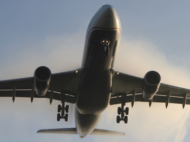 Airbus A330-200 — - A condensation cloud envelopes this US Airways A330-200 as it approaches LHR on a cold autumn day.