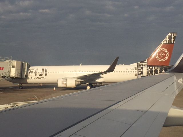 Boeing 737-800 (DQ-FJN) - BEFORE OUR DEPARTURE ON FJ 911 TO YSSY FROM NFFN Fiji i managed to take this photo of the sister aircraft DQ-FJM bound for YBBN/BNE a hour later we were on push back departure row or seat 19A very warm morning at 07:30am