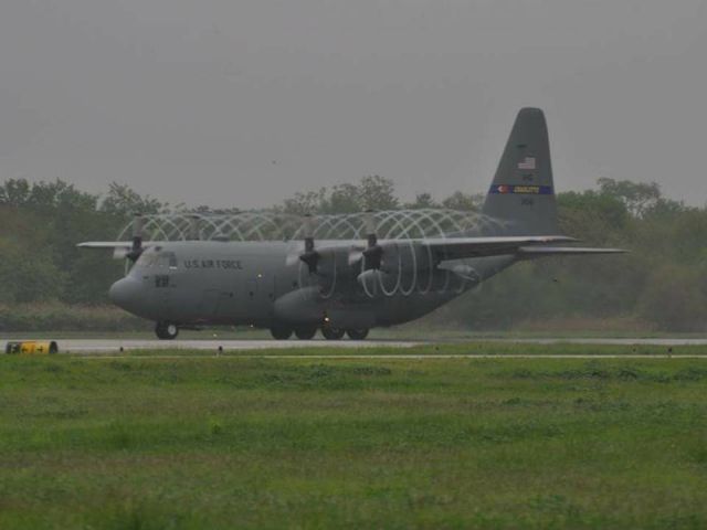 — — - Air Guard C-130 taking off in high humidity