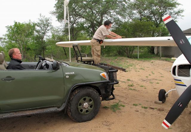 Cessna Centurion (ZS-AVB) - Checking the fuel level at Chitwa Chitwa, South Africa.