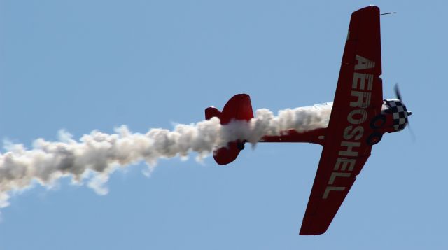 Grumman AA-5 Tiger (N7462C) - Team Aeroshell #1 letting some smoke out for the crowds in the parking lot at Gary Regional Airport