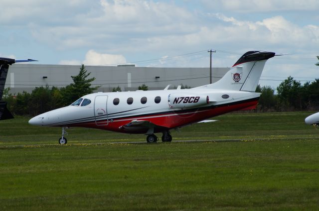 Beechcraft Premier 1 (N79CB) - Stopped in at KMPO. Pocono 400 was running. See if you can guess who's is who's.