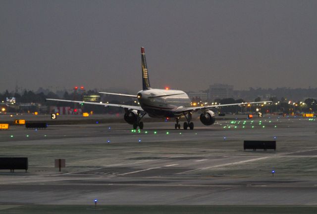 Airbus A319 (N749US) - After a night of routine maintenance at the hangar, this A319 is being taxied to the LAX Los Angeles terminal by Aircraft Maintenance Technicians.