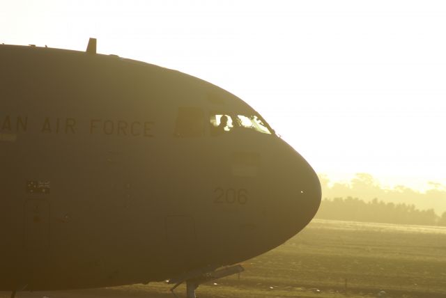 Boeing Globemaster III — - C17 taxying after show - crew silhouetted in setting sun. Avalon Air Show Australia.