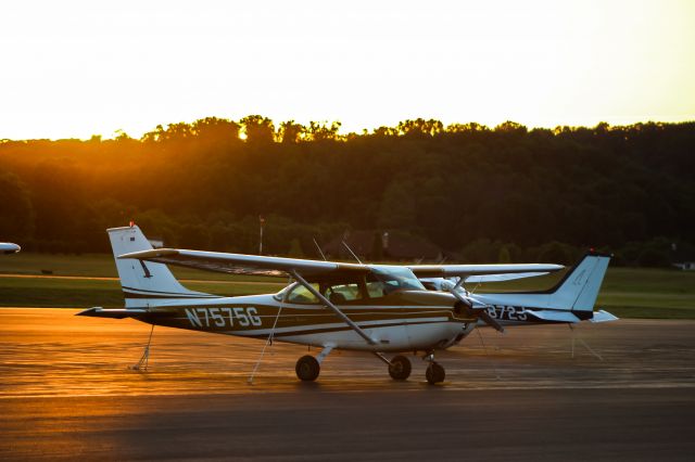 Cessna Skyhawk (N7575G) - Two Cessna 172's sitting on the apron @ KSEG on a summer evening; 7575G is a training plane and 9872J privately owned. The beautiful sunset in the background adds definition to the aircrafts color and paint scheme.