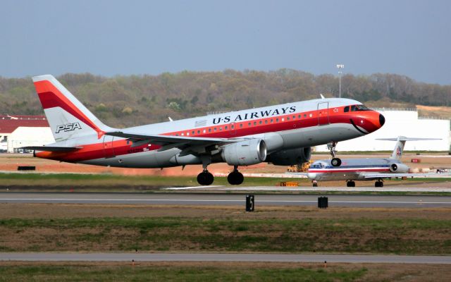 Airbus A319 (N742PS) - A retro A319-112 PSA of US Airways rises above an American MD80 in Nashville, TN. I wonder if AA will one day do a retro plane in US Airways colors?
