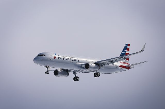 Airbus A321 (N931AM) - American 9707 on final to KBGR 2-16-17 with the fresh 2 feet of snow from the Blizzard of 17 lighting the underside.