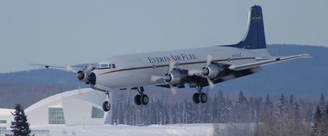 Douglas DC-6 — - Nice shot of a DC-6 with the library from the UAF for a back drop.