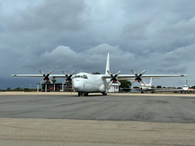 N409LC — - Captured on the military apron of the airport, this civilian c-130 sits with thunderstorms in the background. 