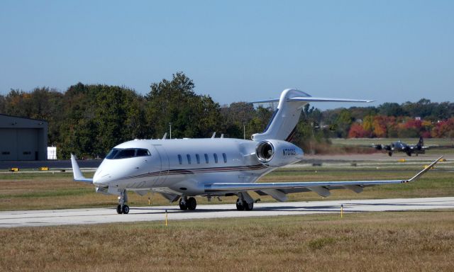 Canadair Challenger 350 (N701QS) - Taxiing for departure is this brand new Canadair Challenger 350 while in the background a 1945 Lockheed B17 "Flying Fortress" catches some tarmac time in the Autumn of 2019.