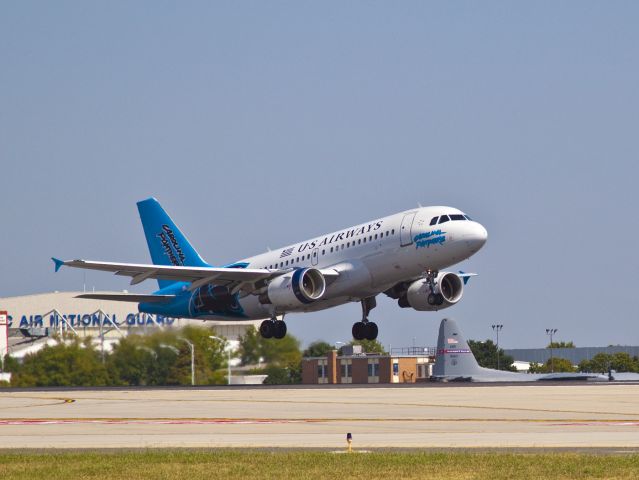 Airbus A319 (N717UW) - Go Panthers! An Airbus A319 featuring the Charlotte Panthers football team paint scheme breaks ground for Washington,DC.