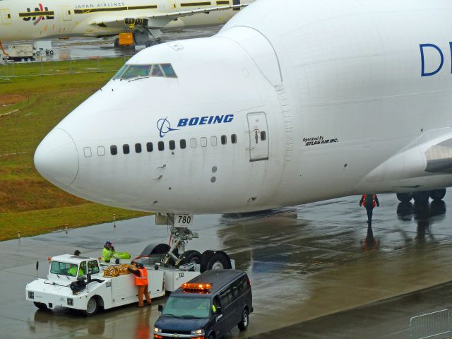 Boeing 747-400 (N718BA) - 1-28-2011 Dreamlifter 747-407 LCF, N718BA is pushed from the Boeing ramp across the main runway at Paint Field in Everett, Washington to the back of the Future of Flight Aviation Center in Mukilteo, Washington.  The Flight Center borders Paine Field. ||| Photo by Bruce McKinnon