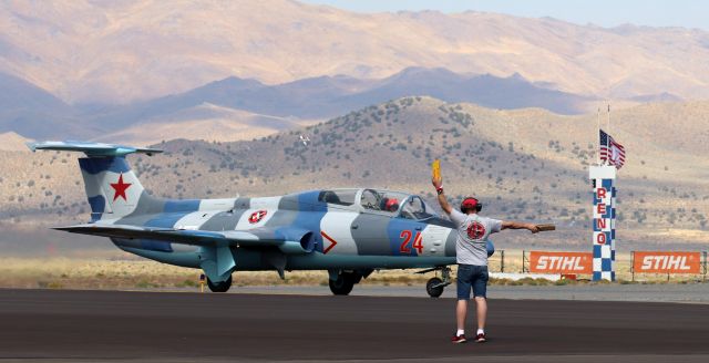 Aero L-29 Delfin (N179EP) - A Jet Class competitor (Race 24, "Just Lucky," N179EP, a 1965 Aerovodochody L-29 Delfin piloted by Peter Zaccagnino) is marshalled by a High Performance Aircraft Racing ground crew agent into a position on the RTS apron after completing a prelim heat race in the 2022 Stihl National Championship Air Races.  (9/15/22)