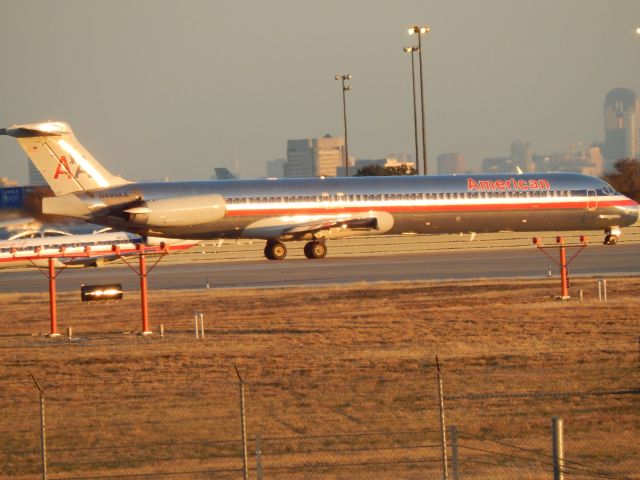 McDonnell Douglas MD-82 (N499AA) - N499AA ready to go on 18L. Texas sunsets are a little bright eh?