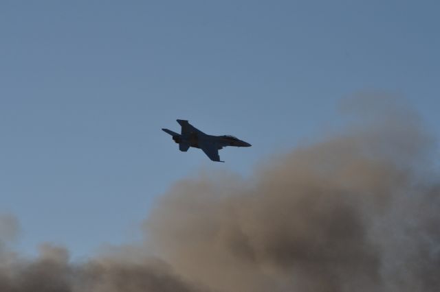 McDonnell Douglas FA-18 Hornet — - F-18 flies over the smoke from a simulated bombing at the Australian International Airshow 2013.