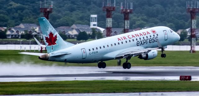 Embraer 175 (C-FUJA) - A Canadian Embraer rotating off a slippery runway 19, headed for Toronto. Full-screen for best resolution.