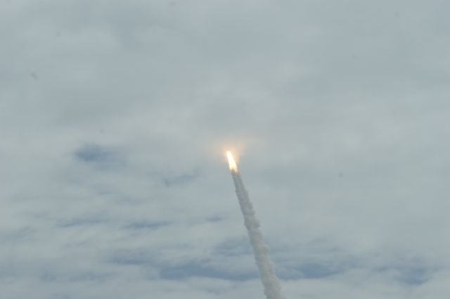 — — - Shuttle Launch just penetrating  clouds