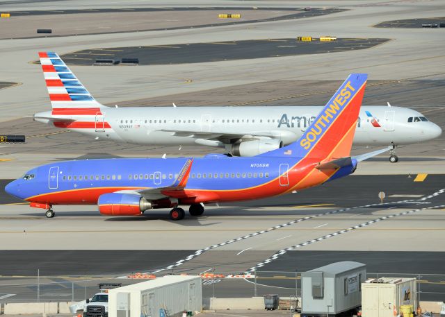 Boeing 737-700 (N705SW) - N705SW is using taxiway T to the gates while N509AY is using taxiway S to the gates. 