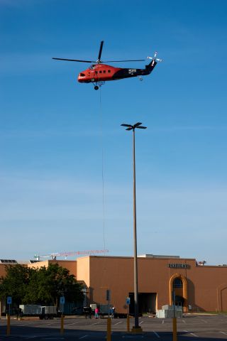 Sikorsky S-58T (N9VY) - 1962 Sikorsky S-58T removing and lifting new HVAC equipment onto the roof of Penn Square Mall in Oklahoma City, OK. Pilot from 5 State Helicopters was a master at the stick and a joy to watch. The downwash was very strong even at 100 yards requiring a fast long lens and good bracing behind a parking lot sign. The "Screaming Mimi" had a staring role in the TV series "Riptide" airing in the mid 1980's.