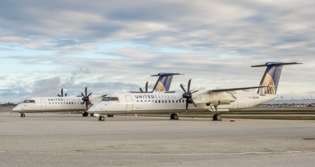 de Havilland Dash 8-400 (N214WQ) - Sitting next to N203WQ at the infield terminal. There were two more at the infield FBO but they are pretty touchy about photos there so I dont bother.