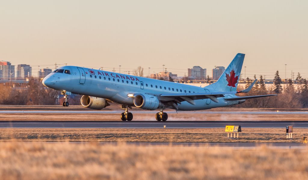 Embraer ERJ-190 (C-FHNL) - Air Canada 708 touches down on runway 05 from Fort McMurray, Alberta. Air Canada phasing out the E190s next year in favour of the C-Series…br /Sun just above the horizon here, March 3rd, 2018 07:08am