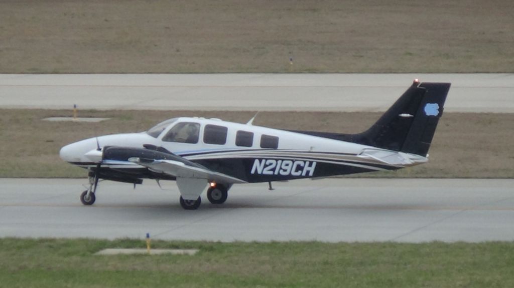 Beechcraft Baron (58) (N219CH) - A common visitor to RDU.  Taken March 19, 2015.