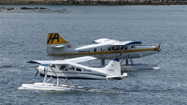 De Havilland Canada DHC-3 Otter (C-GVNL) - A Harbour Air Ltd DHC-3 Otter (Ser#105) taxis to open water while C-FPCG a DHC-2 MK.I Beaver (Ser#1000) of Seair Seaplanes Ltd taxis to the Vancouver, BC air harbour on 5/18/13.