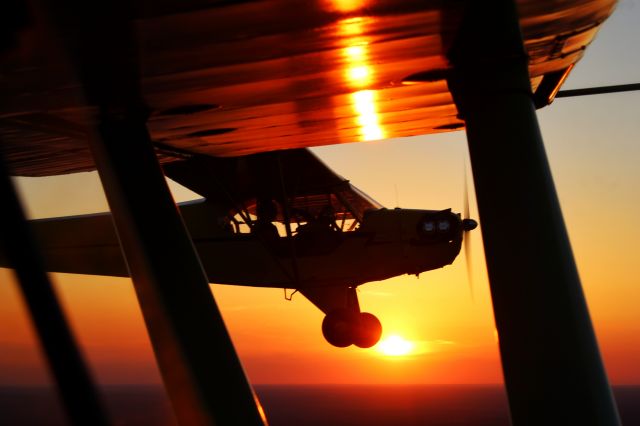 Piper NE Cub (N7430H) - Sunset formation flight with J-3 Cub. Shot taken from a Stinson 108.