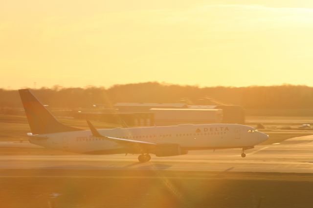 Boeing 737-800 (N385DN) - A Delta 737-800 rotates on Runway 36R as the sun comes in from behind (unedited).