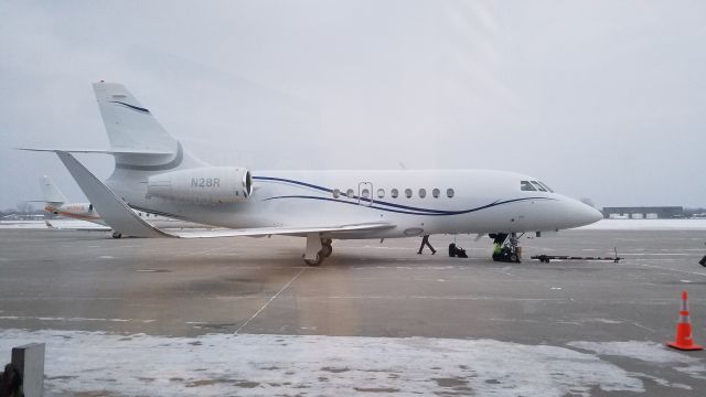 Dassault Falcon 2000 (N28R) - After being towed into position, waiting for pax while a G150 taxis into position on the other side.
