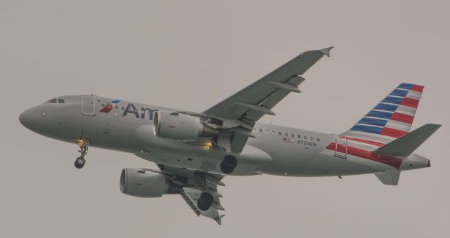 Airbus A319 (N724UW) - AA Baby Bus emerging from the fog on final to BOS.