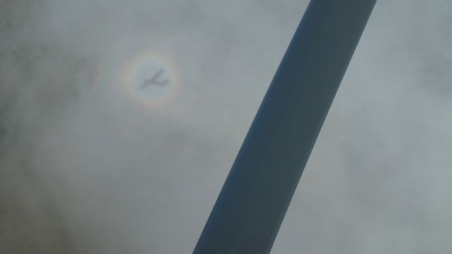 Cessna Skylane RG (N4428R) - Shadow of N4428R with circular rainbow on cloud below plane.