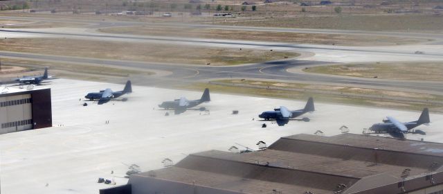 Lockheed C-130 Hercules — - KIRTLAND AIR FORCE BASE-ALBUQUERQUE, NEW MEXICO, USA-OCTOBER 05, 2011: Adjacent to Albuquerque International Airport is Kirtland Air Force Base. Seen in this photo are five C-130 Hercules cargo planes. The military base and the civilian airport share the same runways.