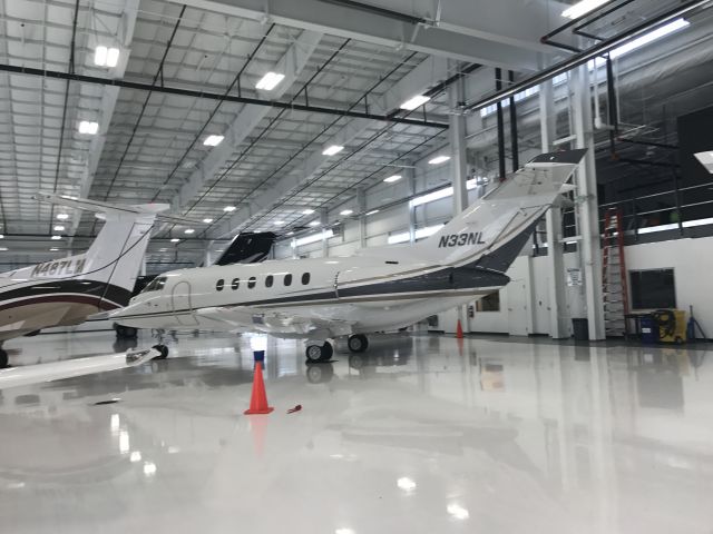 Hawker 800 (N33NL) - In the Aerocolorado hanger with all of the fire pilatuses and Oneflights Gulfstream G3