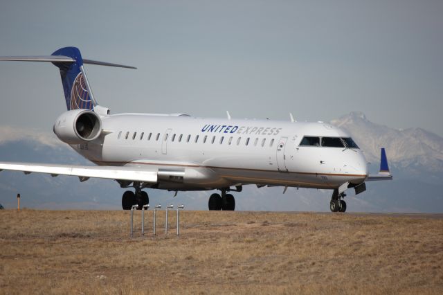 Canadair Regional Jet CRJ-700 (N730SK) - On taxiway CN with Longs Peak in the background.