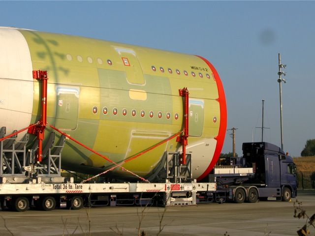 Airbus A380-800 — - Airbus A380 parts being trailered to Toulouse for assembly. They arrive on the French coast from England and Germany and are moved to Toulouse by night (about 40KM) per day.