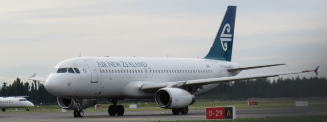 Airbus A320 (ZK-OJO) - This is the old livery Air New Zealand taxiing to runway 02 with a Bombardier Dash 8 Q300 in the background.