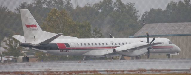 Saab 2000 (N511RH) - Heavy rain, photo taken from inside my car through a cyclone fence.  Two NASCAR affiliations nearby.  Road Atlanta is used for testing and driver training.  All NASCAR Carburetors are made 50 miles north of here in Dahlonega, GA