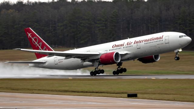 Boeing 777-200 (N846AX) - What an absolute treat this was! Seen here is one of Omni Air Intl's departing carrying Jackson State Sonic Boom of the South band to California. You can actually catch this one arriving on NEXJET 12/28 live stream around the 3:42:33 mark.br /br /I'm a bit bummed about the lighting, as it was not only black, low clouds but also raining during this departure, causing noticeable imperfections. However, I'm extremely happy to have been able to capture this gorgeous former Kenya Airways 772ER departing and giving off water effects as well as a noticeable vortex over the inner wing/starboard engine area!