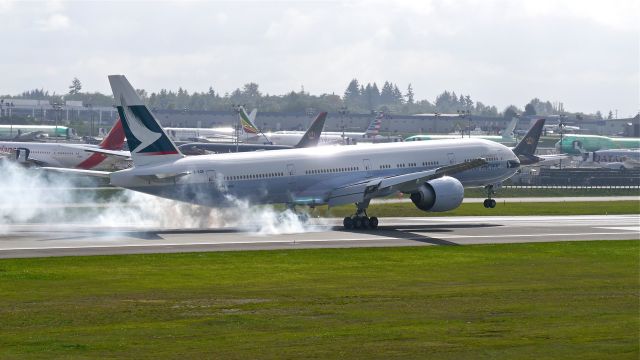 BOEING 777-300 (B-KQR) - BOE249 makes tire smoke on landing Rwy 16R to complete a flight test on 10/1/14. (LN:1240 / cn 41759).