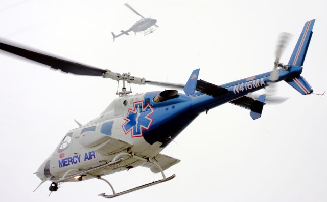 — — - The Mercy Air medivac helicopter comes in low over the Iowa Speedway infield as the ABC News helicopter hovers overhead in preparation for the 1st annual INDY Corn 250 race.