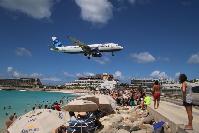 N634JB — - One of the stops that I was most excited about on our week-long Eastern Caribbean Cruise to San Juan, Puerto Rico, St. Maarten, and St. Kitts on the Celebrity Equinox (February 17-24, 2018), was St. Maarten.  The island, that was hit very badly during hurricane season last year, especially Irma (more pictures later) and this was only the second time since that storm that the Equinox has arrived at the port of Philipsburg, St. Maarten.  You can see the damage on some of the buildings near the beach. One of the experiences I wanted to capture was plane watching on Maho Beach as planes approached Princess Juliana Airport (SXM).  The beach is very narrow after the storm and with extensive damage to the airport, fewer flights are coming in.  While we saw many small planes, we did see a JetBlue A320 which was kinda cool.  The Delta flight supposedly arriving at 12:05 never made it or was delayed.  Wish we saw more - but when bird watching or plane watching - you see what you see.  Still the Maho Airplane Experience was a great excursion and I am glad I went.  