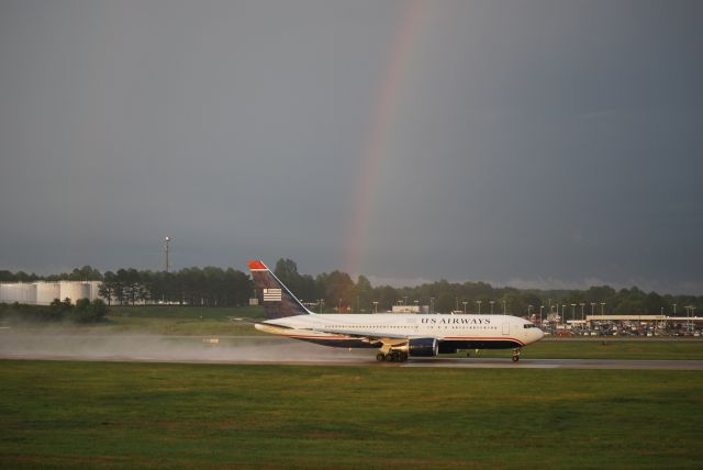 BOEING 767-200 (N249AU) - Rolling 18C in rain and sun with a rainbow that literally was coming from the taxiway just behind the aircraft - 5/27/11