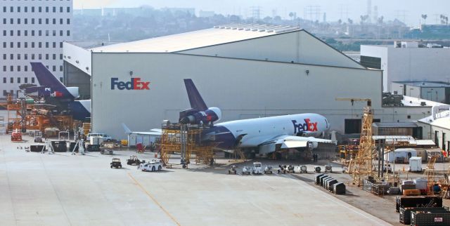 Boeing MD-11 (N590FE) - FDXs Stan (N590FE) is one of a pair of MD-11s undergoing MX work at the Fed Ex heavy maintenance hangar at LAX.